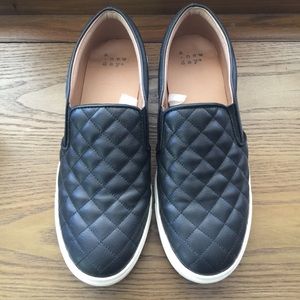 Black quilted slip on sneakers